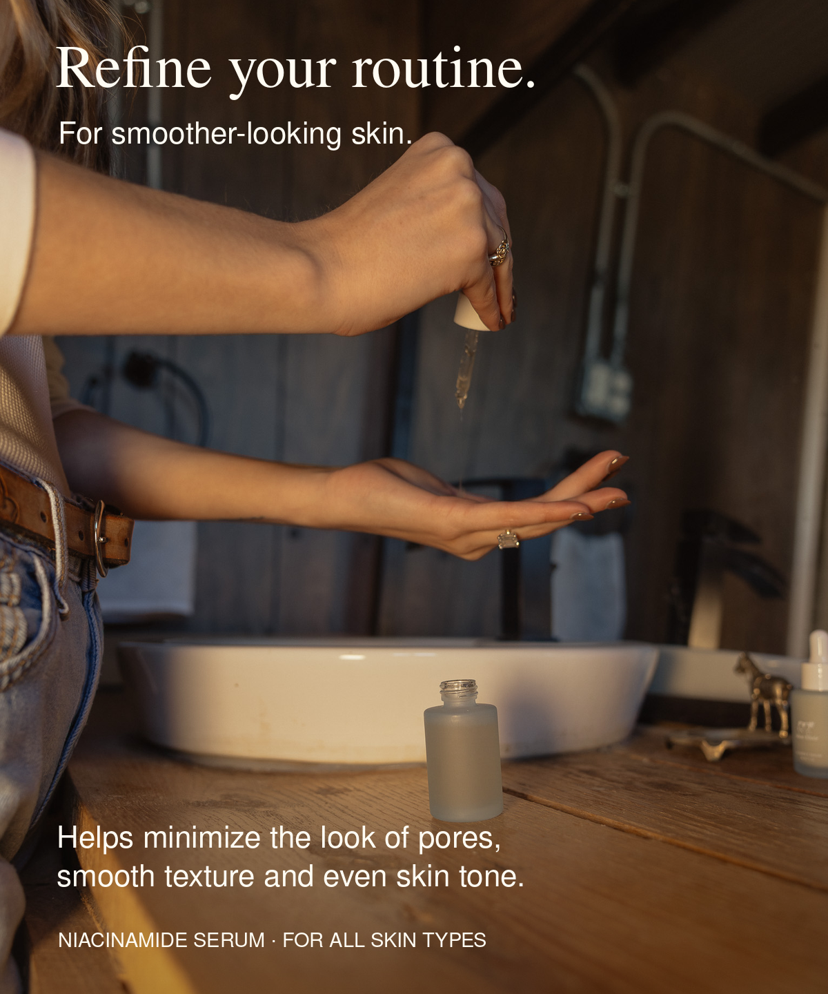 Person dispensing Moo Elixir Niacinamide Serum into their palm beside a bathroom sink. Text reads: “Refine your routine. For smoother-looking skin. Helps minimize the look of pores, smooth texture and even skin tone. Niacinamide Serum · For all skin types.”