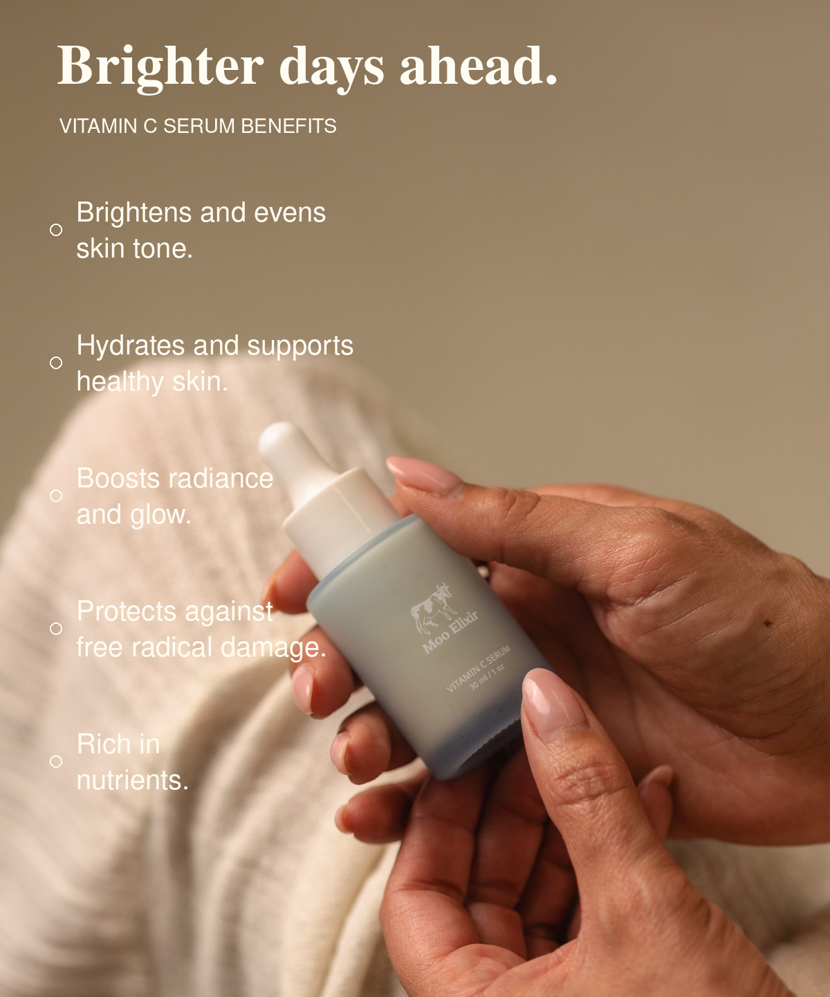 Hands holding a Moo Elixir Vitamin C Serum dropper bottle. Text reads: “Brighter days ahead. Vitamin C Serum benefits: Brightens and evens skin tone. Hydrates and supports healthy skin. Boosts radiance and glow. Protects against free radical damage. Rich in nutrients.”